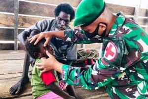 Satgas Yonif 125/Simbisa  saat memberikan pelayanan kesehatan kepada masyarakat Kampung Rawa Biru.